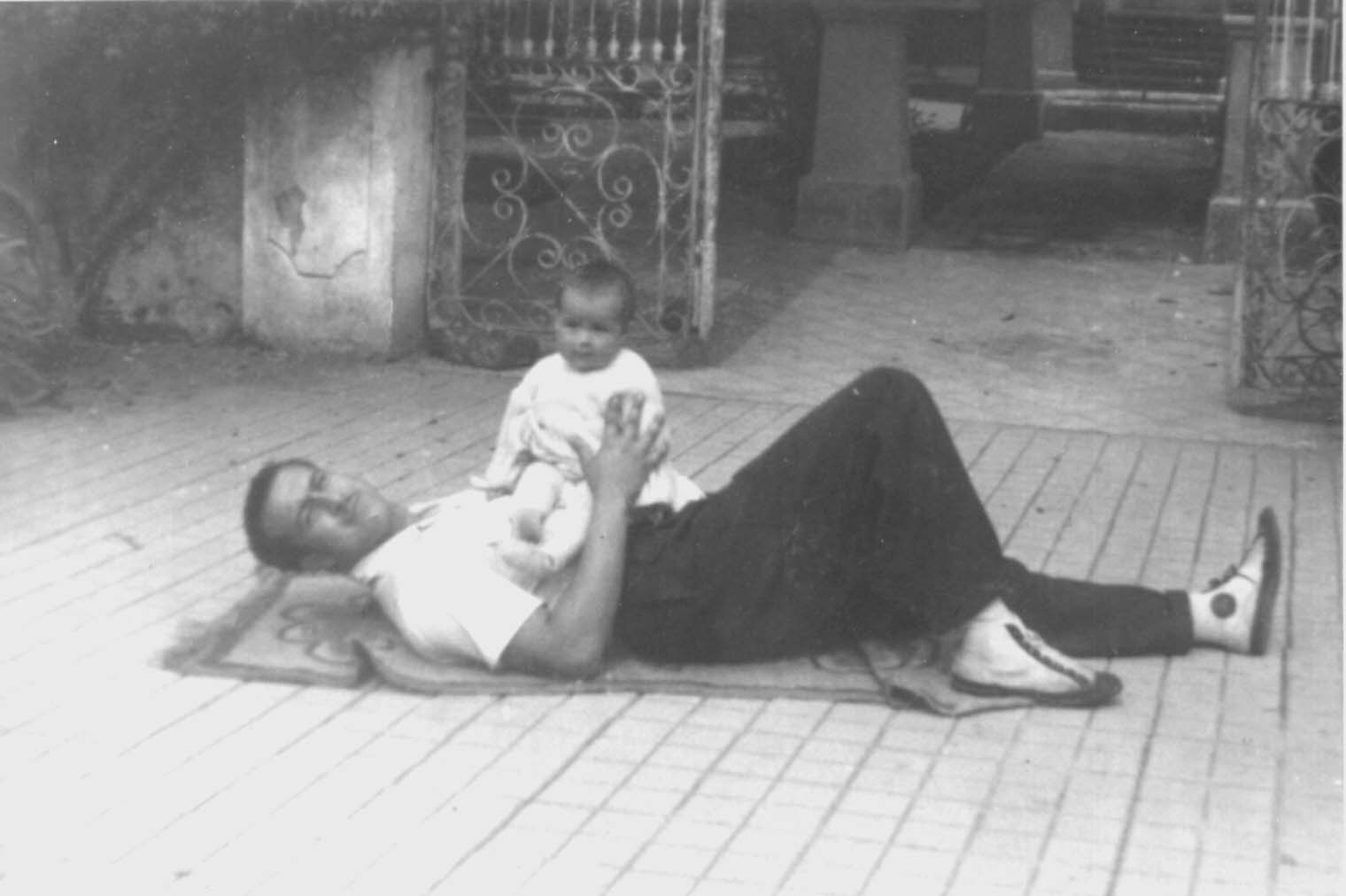 Everardo with Lucy in front of their new home in Toluca.